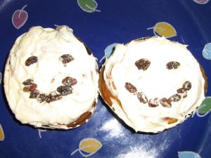 two smiley face cupcakes